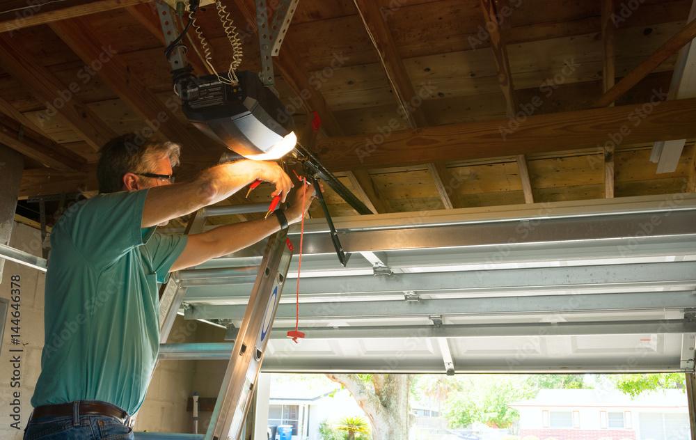 technician fixing garage door opener trolley