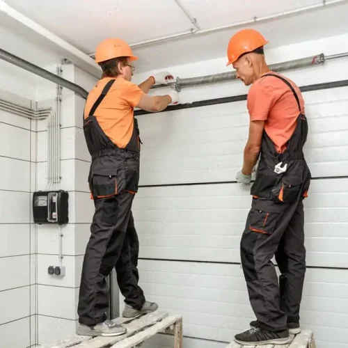 service techs working on torsion spring