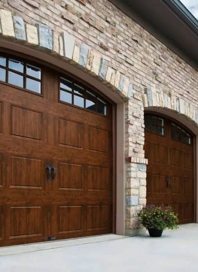 brick house with brown garage doors