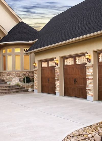 3 brown garage doors with windows