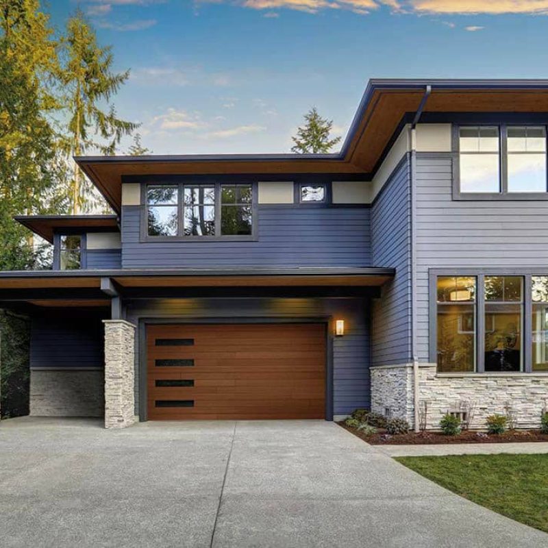house with brown garage door and window column on the left