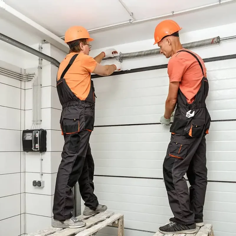 garage door techs working on torsion garage door spring