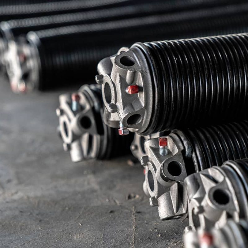 oil tempered garage door torsion springs in a pile