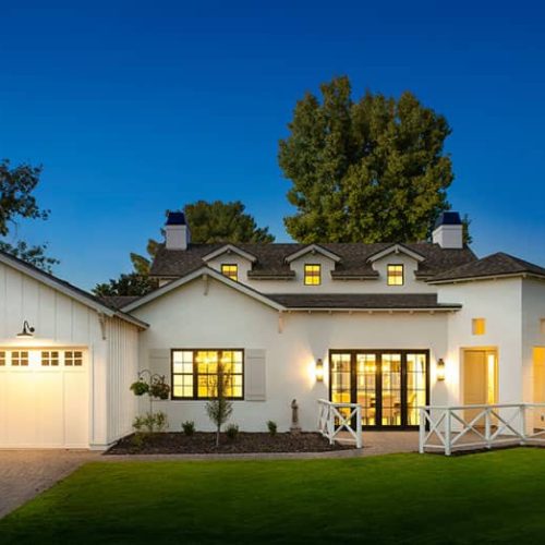 white house with white garage doors and ligthing