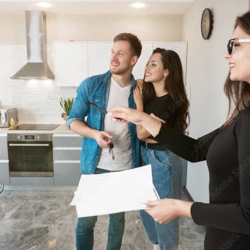 two people and a realtor looking at a house