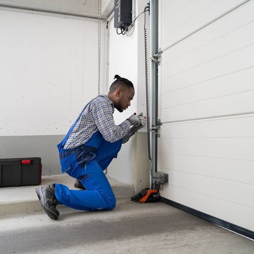 technician working on a garage door