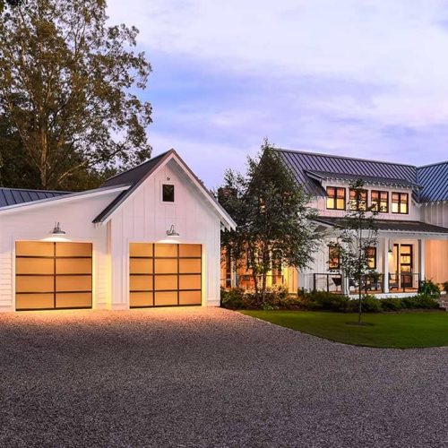 white home and garage with brown garage doors